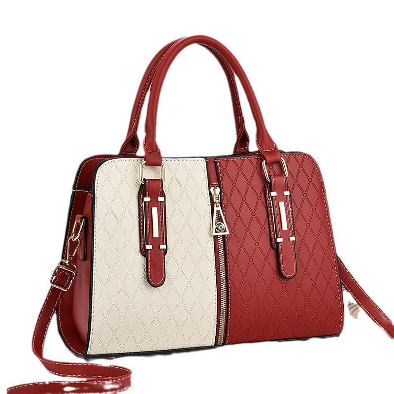 Fashion color matching ladies handbag with embossed red and cream panels, large capacity, and versatile carry options.