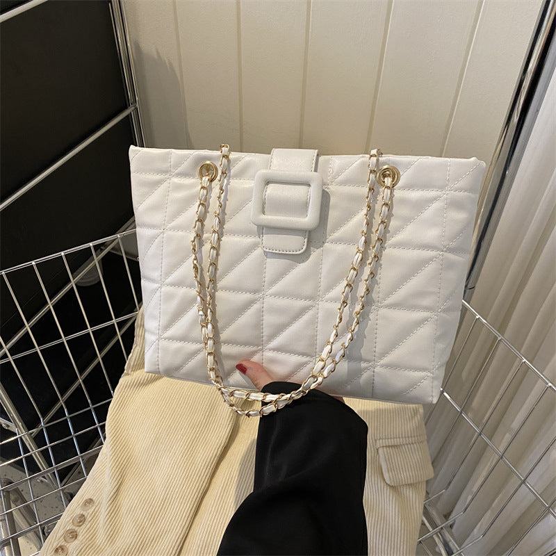 White quilted women shoulder bag with rhombus pattern and gold chain strap, soft PU leather, trapezoid shape, stylish and compact for daily use