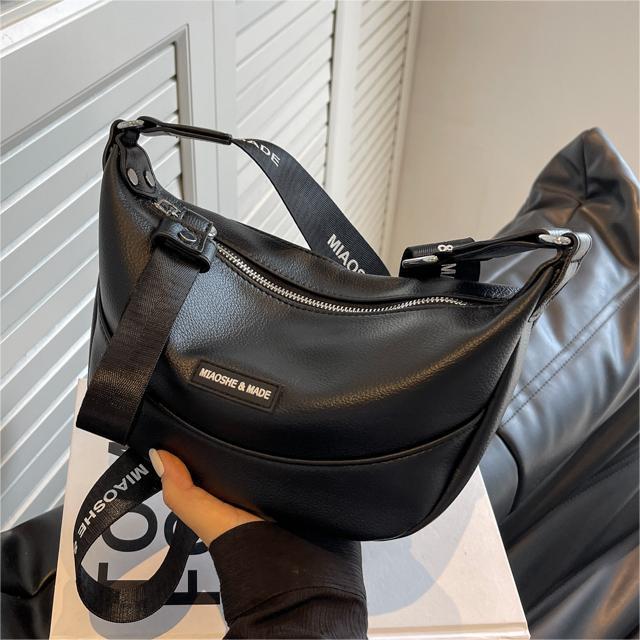 Black versatile dumpling crossbody bag with adjustable shoulder strap and zipper closure