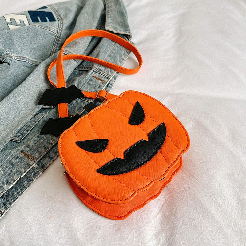 Orange pumpkin-shaped Halloween crossbody bag with black bat accents and adjustable strap