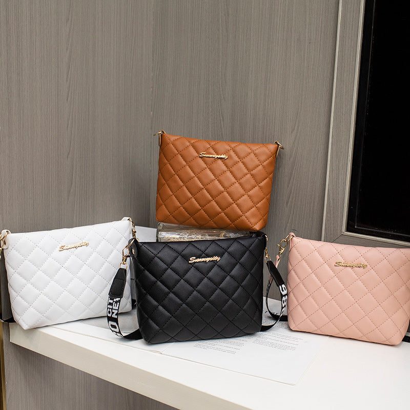 Four small messenger bags for women in white, brown, black, and pink with quilted diamond pattern and chain shoulder straps.