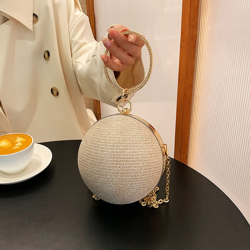 Elegant circular ring luxury evening bag with metal silver round ball design, compact clutch for essentials.