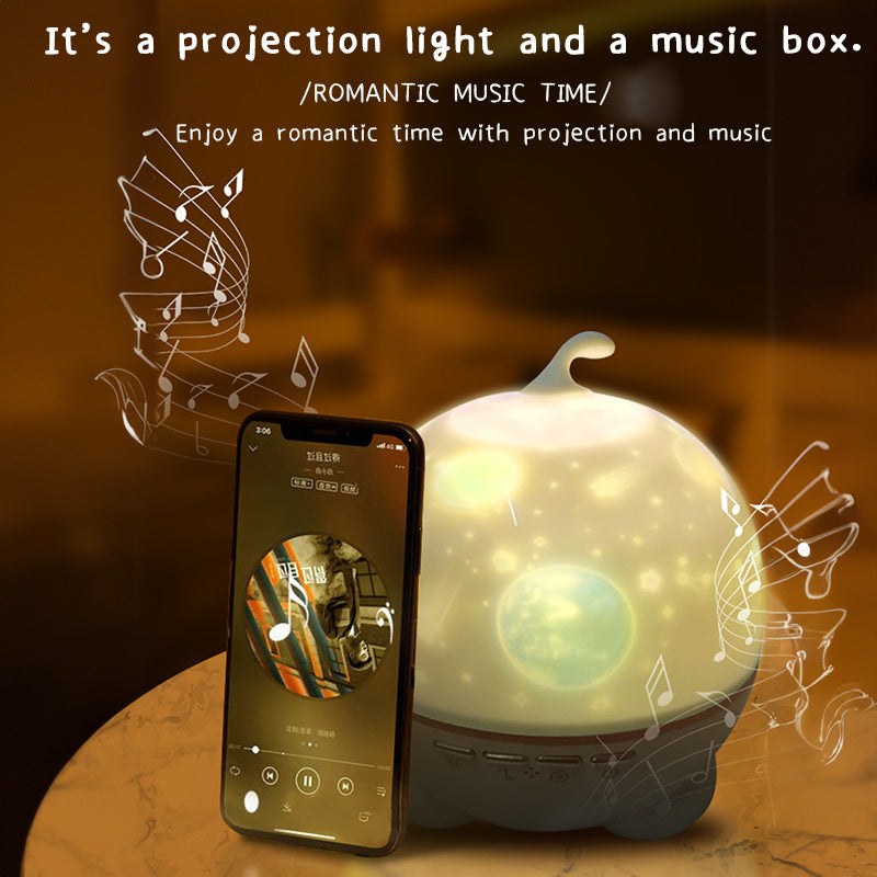 Starry Night light projector with music box showing colorful stars and moons creating romantic atmosphere next to smartphone playing music