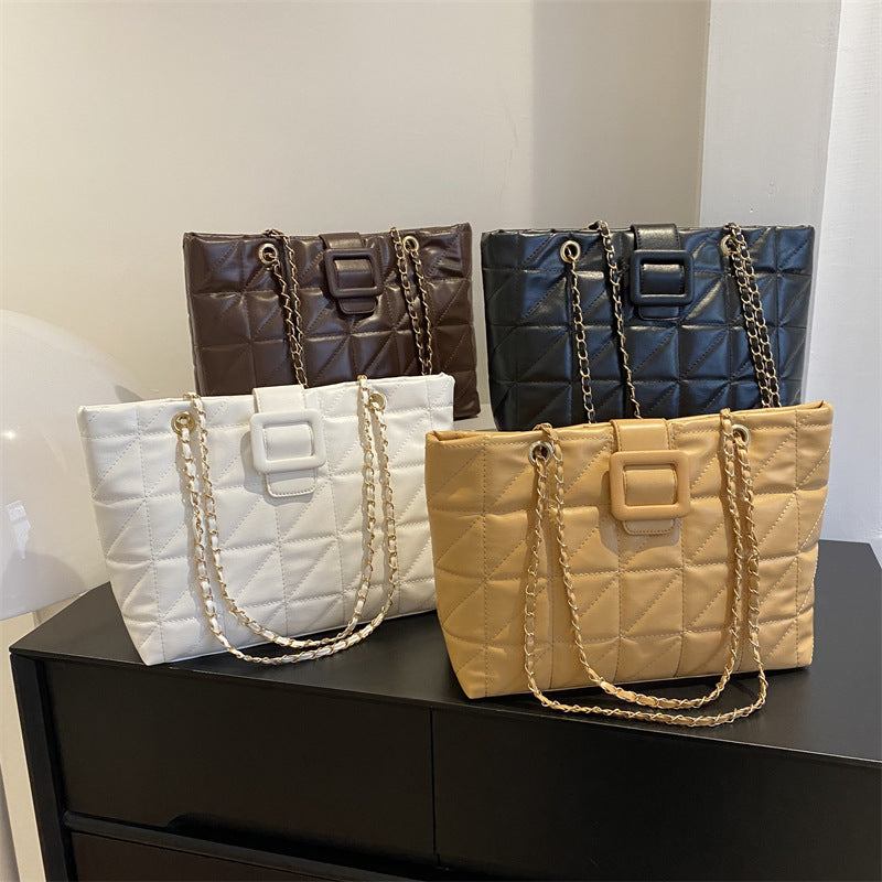 Set of trendy women shoulder bags in black, white, khaki, and brown with quilted rhombus pattern and chain straps.