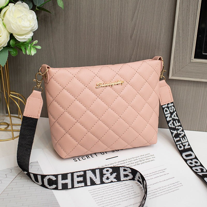 Small pink quilted messenger bag for women with black and white adjustable strap and gold logo detail