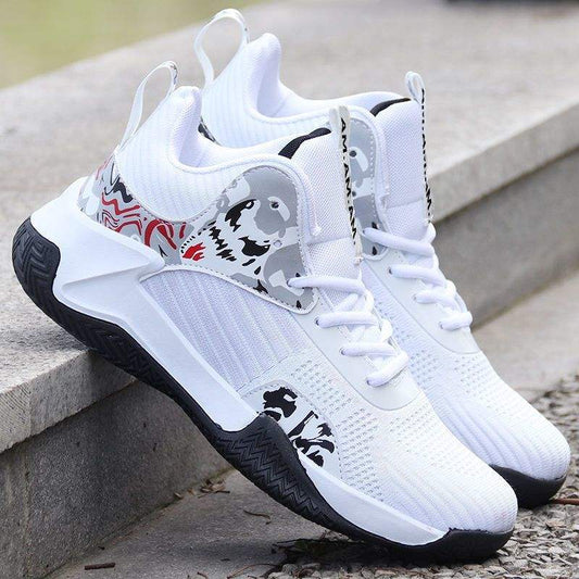 White and black men's breathable basketball sneakers with mid-top design and non-slip rubber soles sitting on outdoor concrete steps