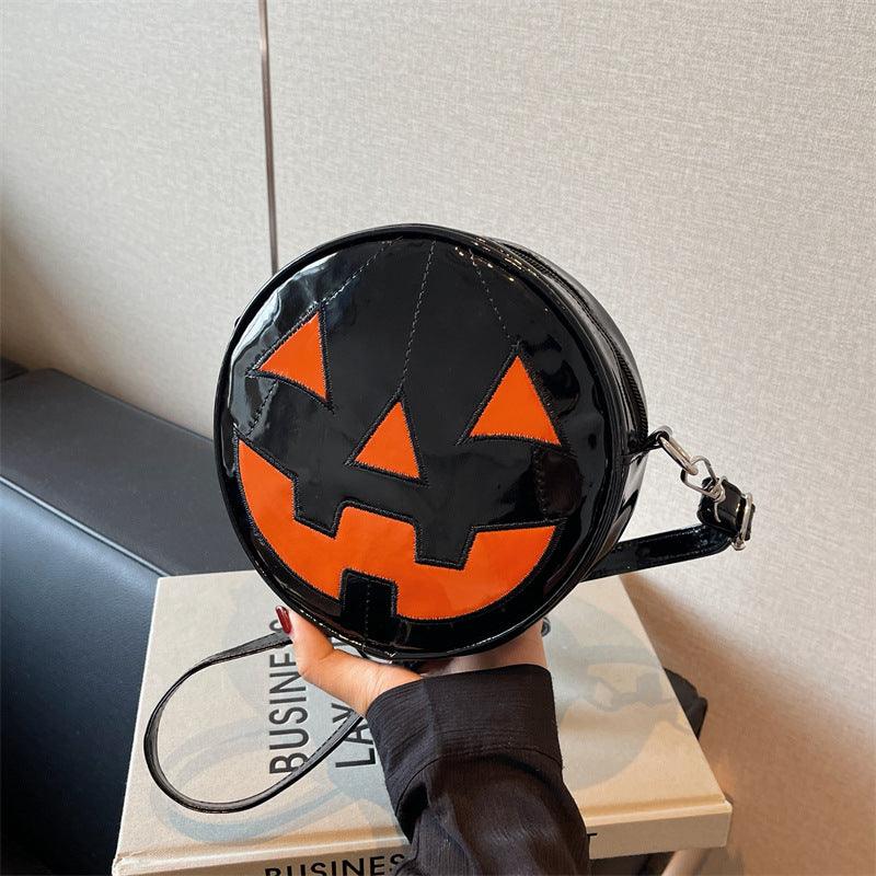 Small Halloween pumpkin shoulder bag with black and orange design, crossbody style for women